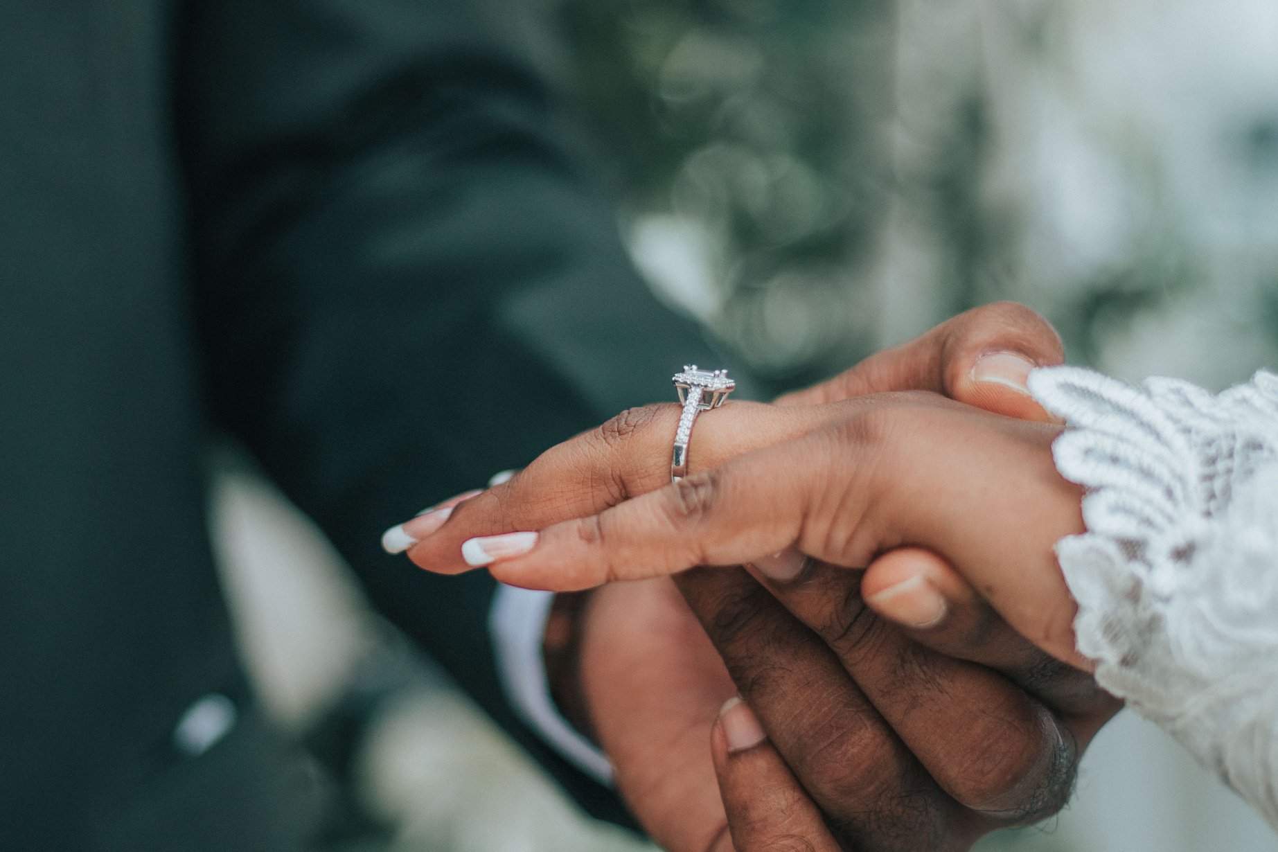 Hands of faceless wedding couple